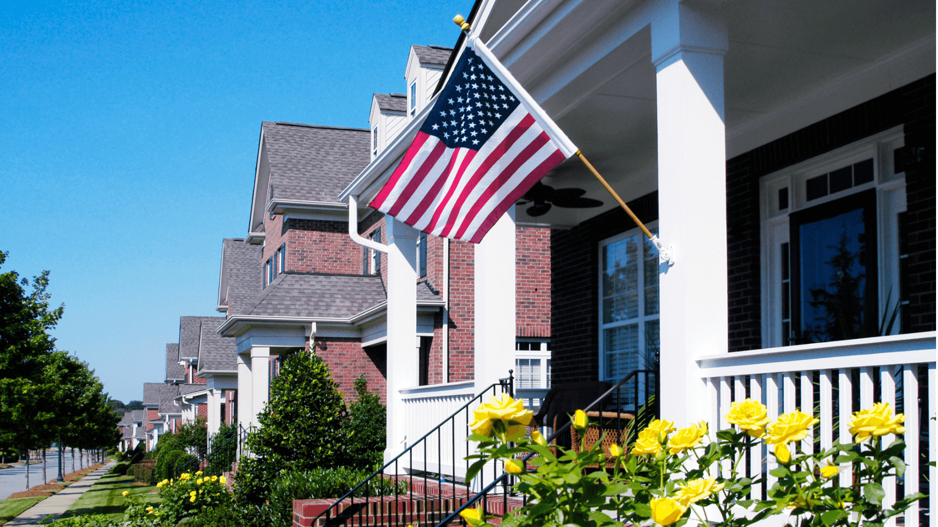 Beautiful bright porch with an American flag and flowers