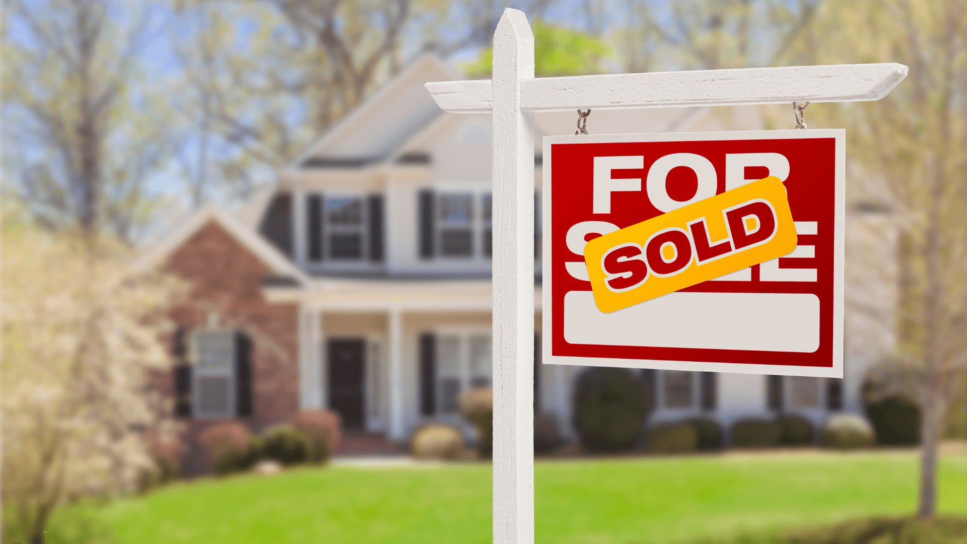 House with a for sale sign in front of it 