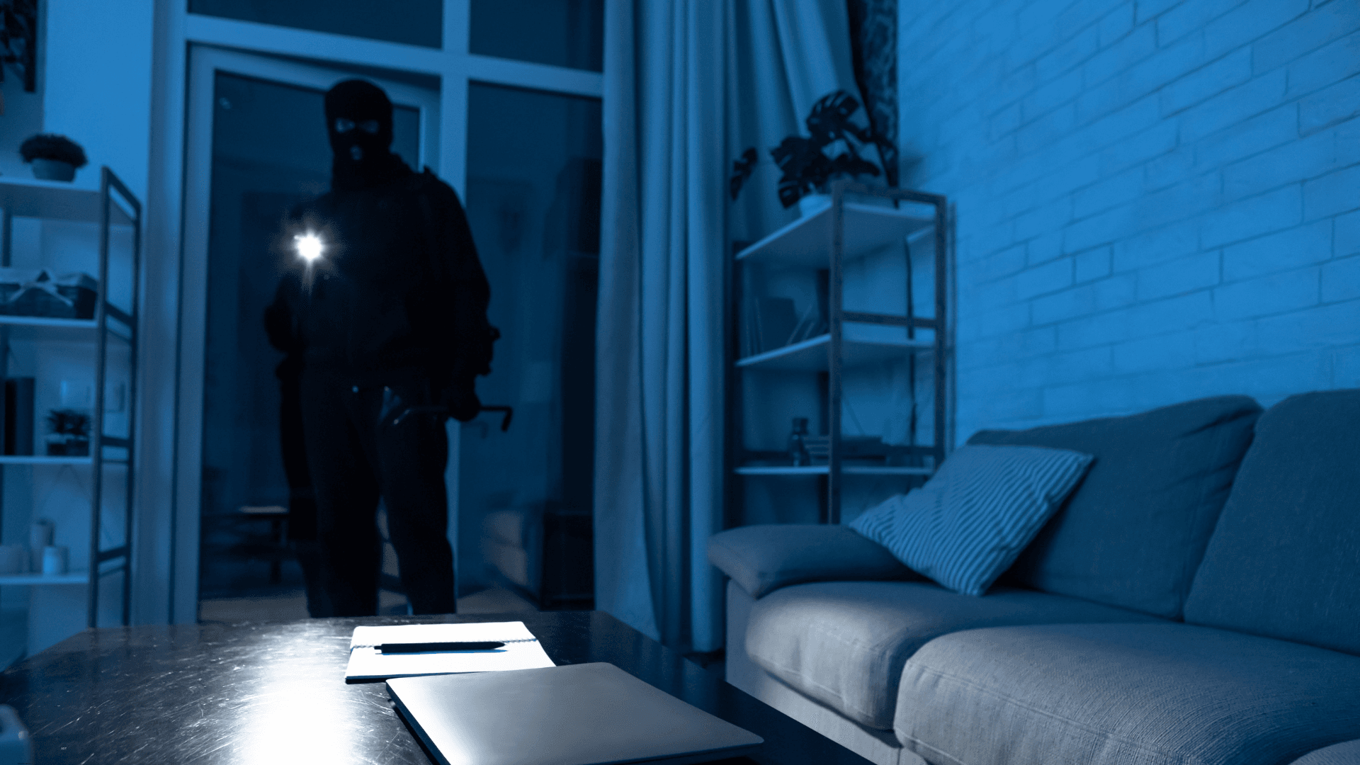 Man in the dark breaking into a home 